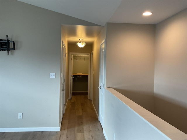 hallway with light hardwood / wood-style floors