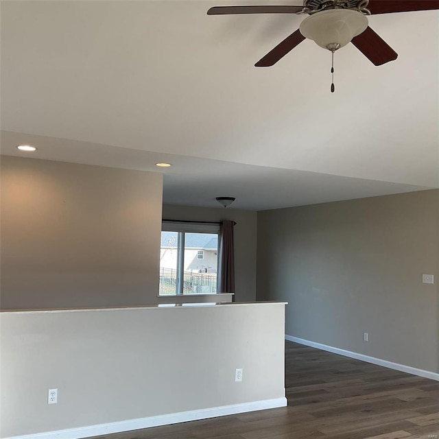 spare room with ceiling fan and dark wood-type flooring