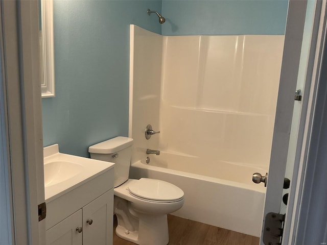 full bathroom featuring shower / washtub combination, hardwood / wood-style floors, vanity, and toilet