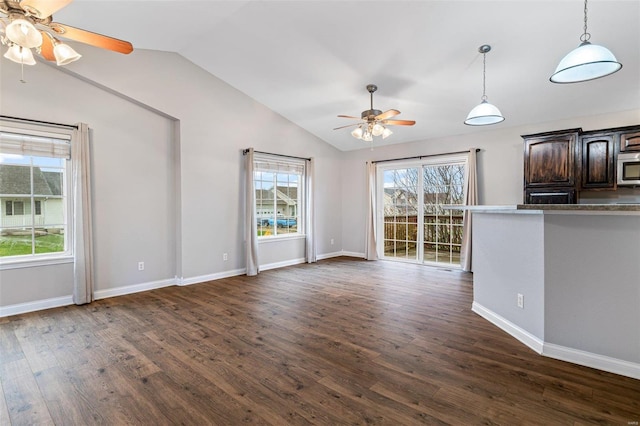 unfurnished living room featuring vaulted ceiling and dark wood-type flooring