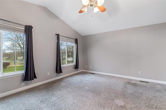 carpeted spare room with ceiling fan and lofted ceiling