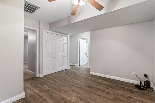 interior space featuring a closet, ceiling fan, and dark hardwood / wood-style floors