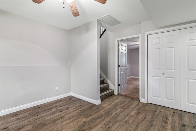 basement featuring ceiling fan and dark wood-type flooring