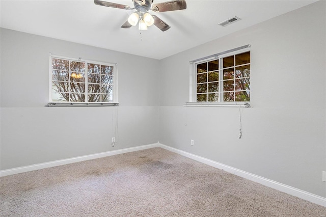 carpeted empty room featuring ceiling fan and a healthy amount of sunlight