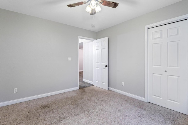 unfurnished bedroom featuring ceiling fan, a closet, and carpet