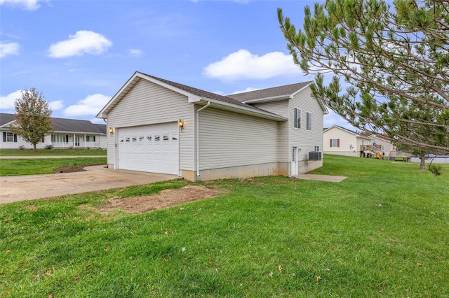 view of home's exterior featuring a lawn and a garage