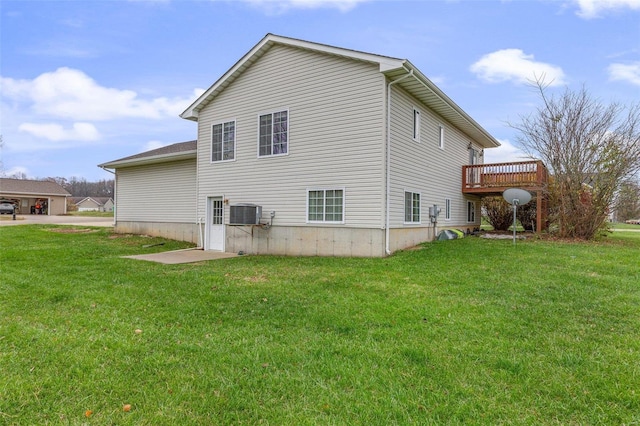 rear view of house featuring a deck, cooling unit, and a lawn