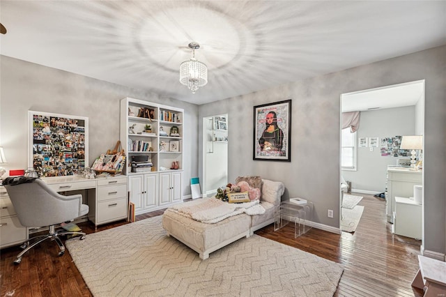 office featuring wood-type flooring and an inviting chandelier