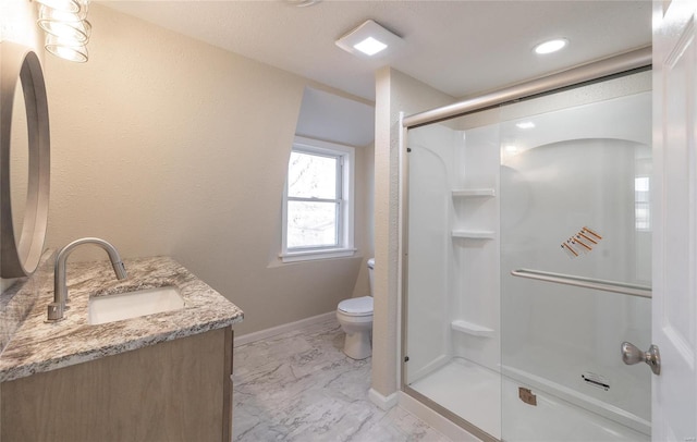 full bathroom featuring vanity, baseboards, a shower stall, toilet, and marble finish floor