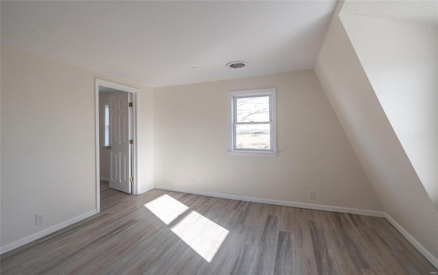 bonus room with visible vents, baseboards, and wood finished floors