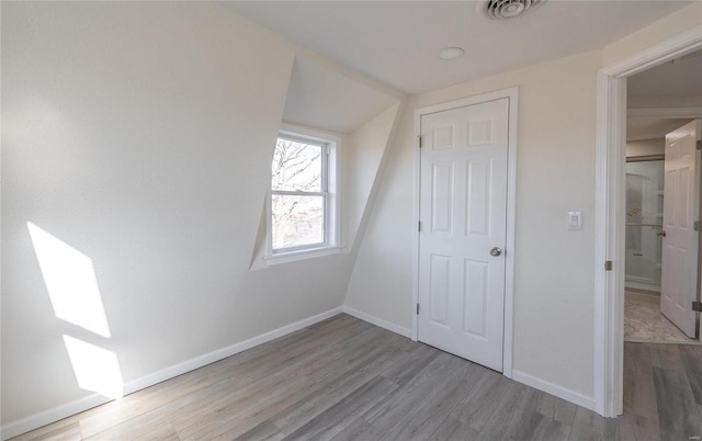 bonus room with visible vents, baseboards, and wood finished floors