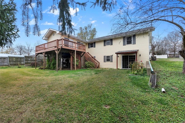 rear view of property with a lawn and a deck