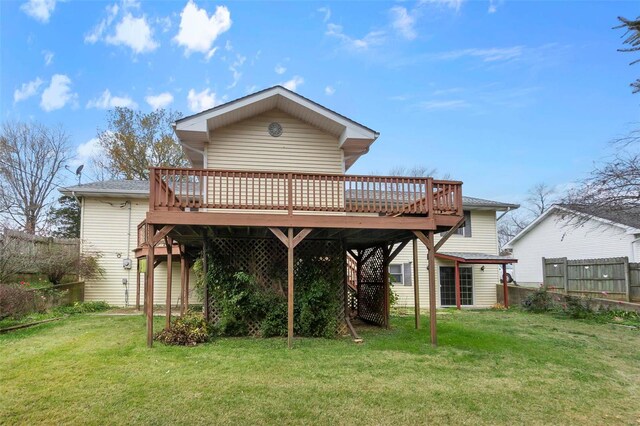 back of house featuring a wooden deck and a yard