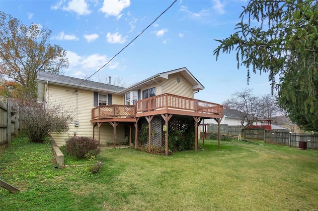 rear view of property with a lawn and a deck