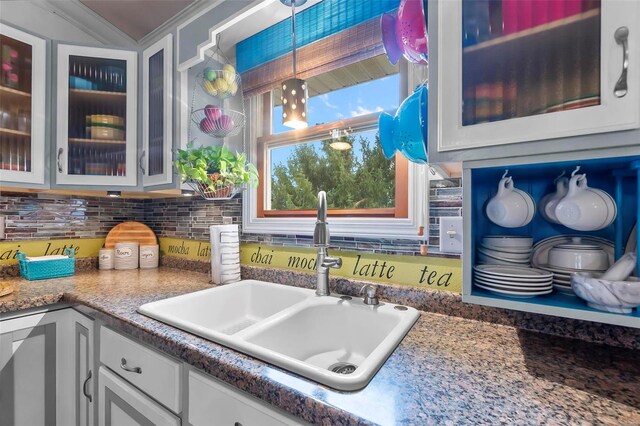 kitchen featuring decorative backsplash, crown molding, sink, pendant lighting, and white cabinets