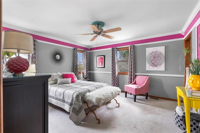 carpeted bedroom with ceiling fan and crown molding