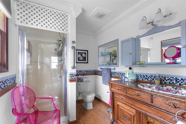 bathroom featuring hardwood / wood-style floors, an enclosed shower, toilet, vanity, and ornamental molding