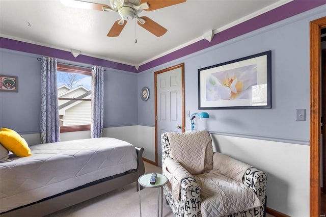 bedroom with ceiling fan and crown molding