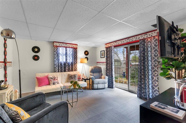 living room with a drop ceiling