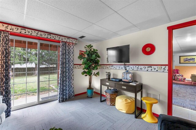 recreation room with carpet flooring and a paneled ceiling