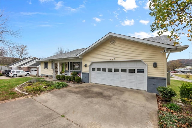 single story home featuring a porch and a garage