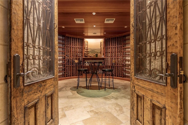 wine area featuring recessed lighting, wooden ceiling, and stone finish flooring