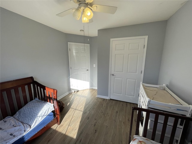 bedroom with ceiling fan and dark hardwood / wood-style flooring