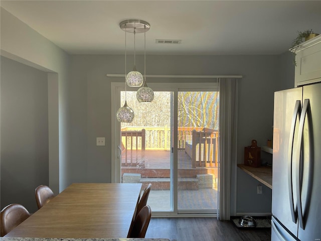 dining area featuring dark wood-type flooring