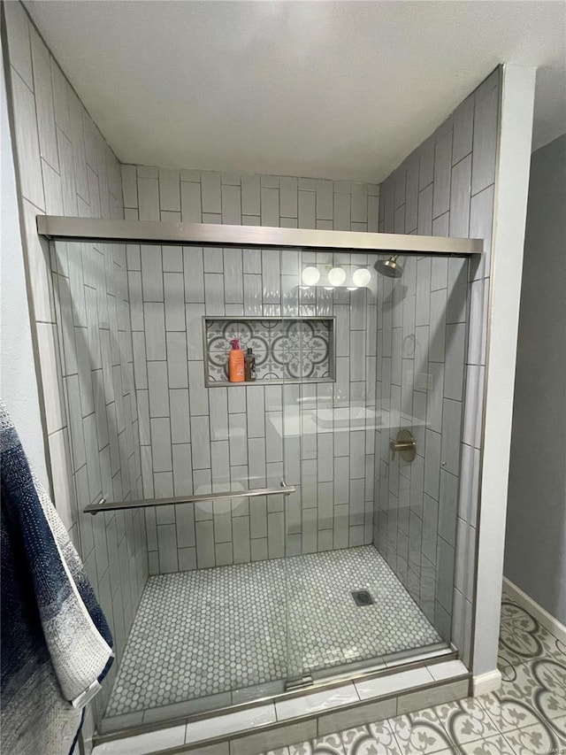 bathroom featuring tile patterned floors and an enclosed shower