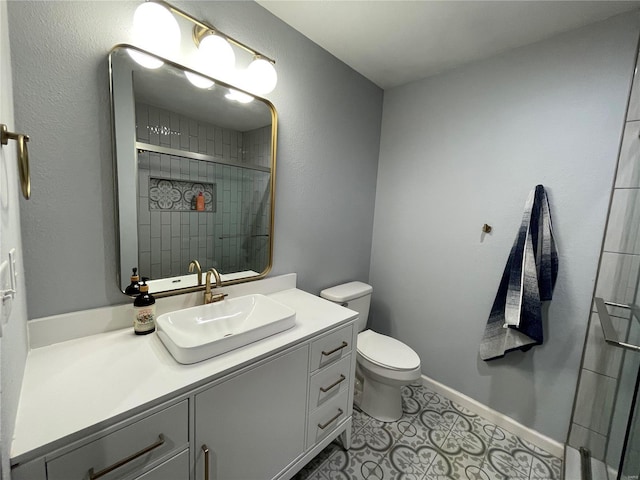 bathroom featuring tile patterned floors, vanity, tiled shower, and toilet