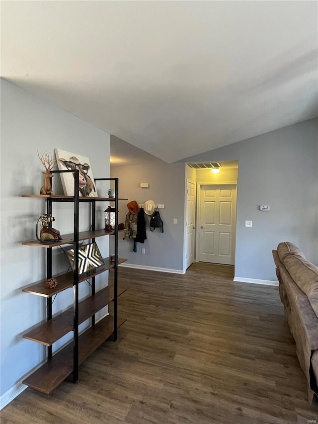 foyer featuring dark hardwood / wood-style floors and vaulted ceiling