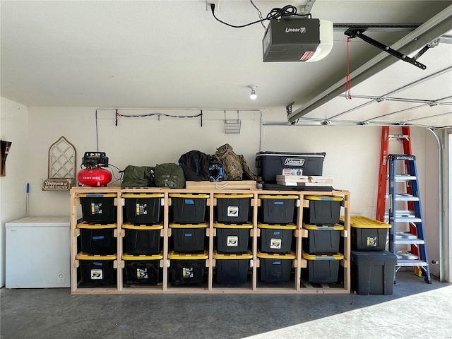 garage featuring refrigerator and a garage door opener