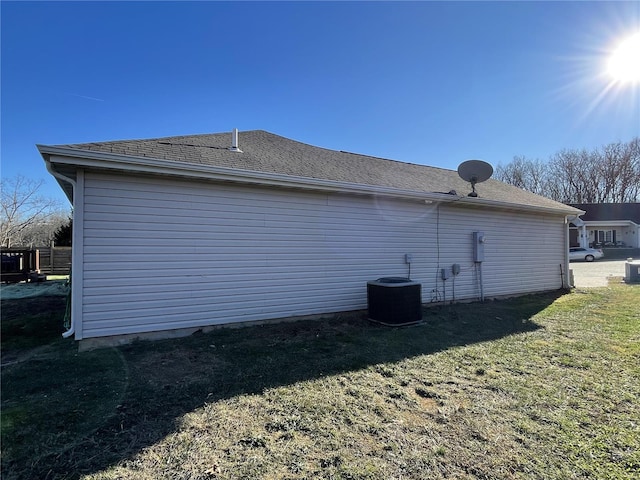 view of property exterior featuring a lawn and cooling unit