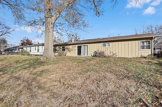 back of house with a lawn