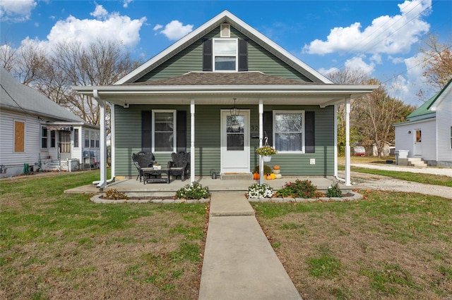 bungalow featuring a porch and a front yard