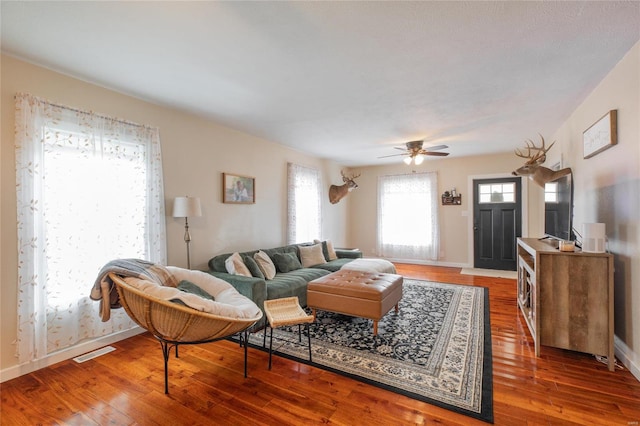 living room featuring ceiling fan and hardwood / wood-style floors