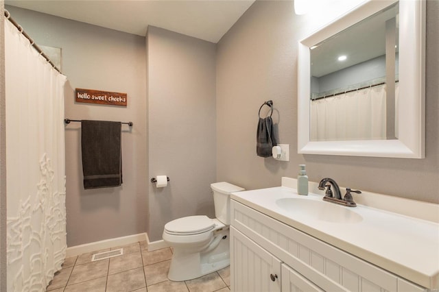 bathroom featuring toilet, vanity, and tile patterned floors