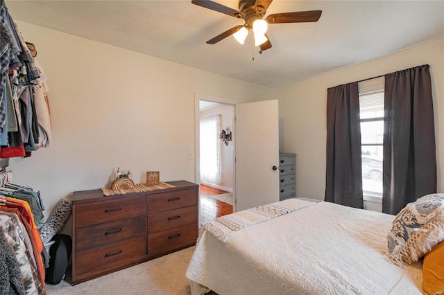 bedroom featuring ceiling fan and light carpet