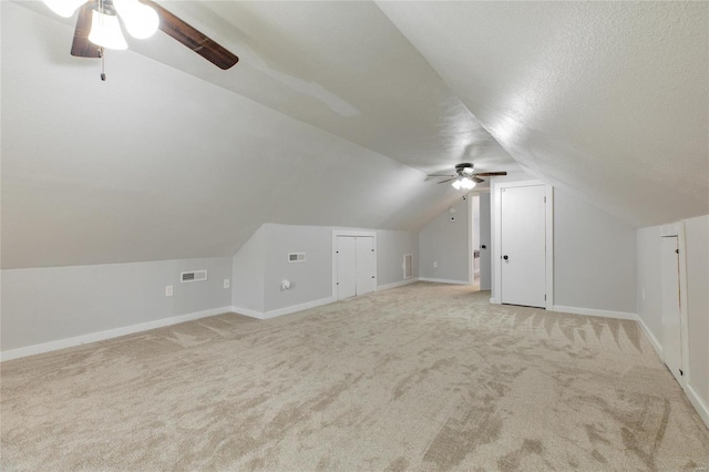 bonus room with ceiling fan, light colored carpet, and lofted ceiling