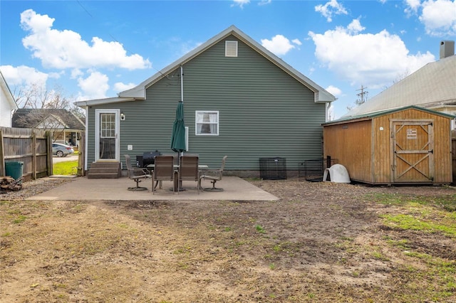 back of property with a patio and a storage unit