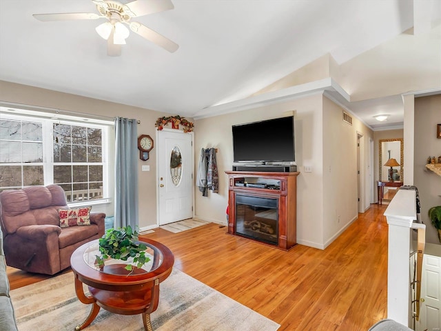 living room with ceiling fan, light hardwood / wood-style floors, and lofted ceiling