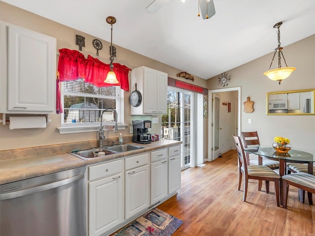 kitchen featuring dishwasher, sink, hanging light fixtures, light hardwood / wood-style flooring, and white cabinets