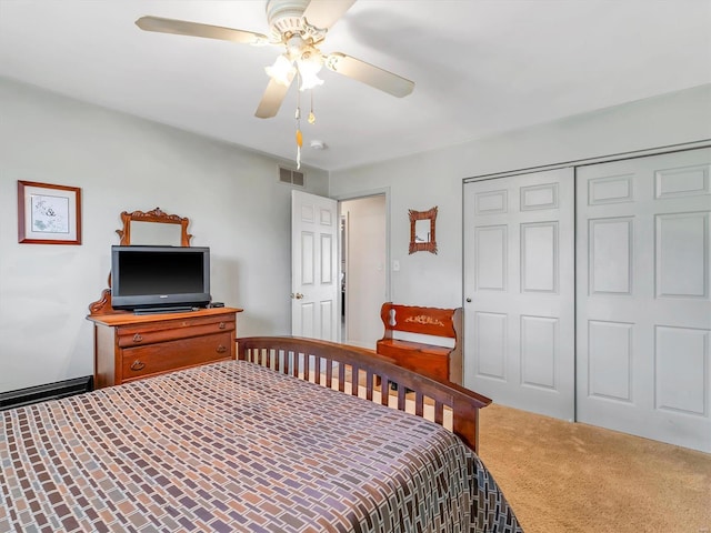 carpeted bedroom with ceiling fan and a closet