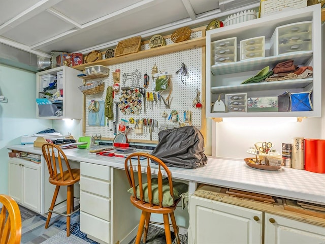 interior space with a kitchen breakfast bar and white cabinets