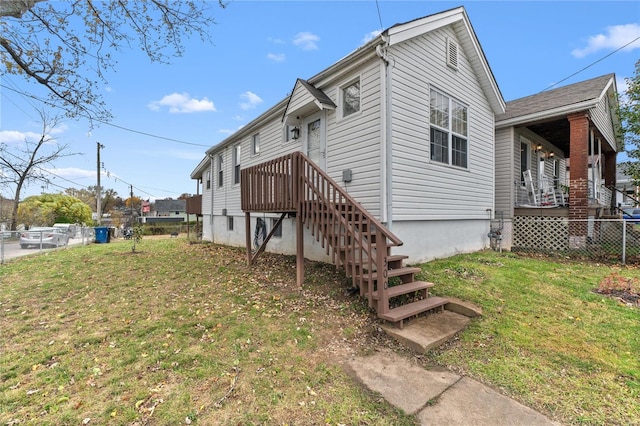 view of side of property with a yard