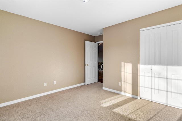 unfurnished bedroom with carpet flooring and a closet