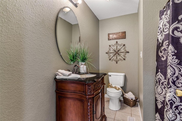 bathroom with tile patterned floors, vanity, and toilet