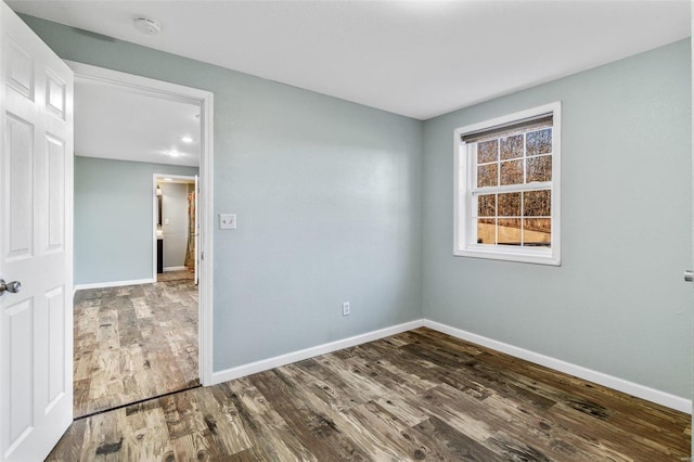 spare room with dark hardwood / wood-style flooring