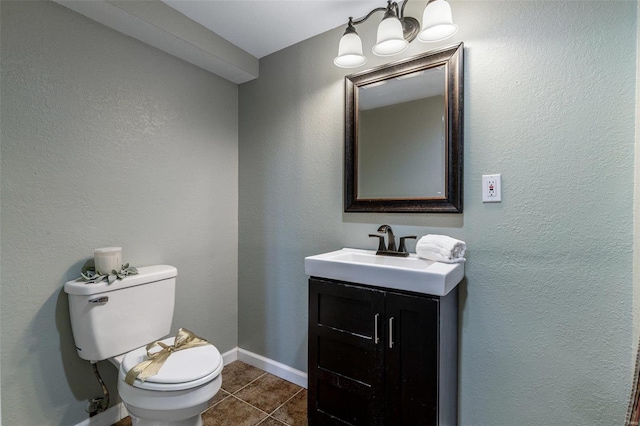 bathroom with tile patterned flooring, vanity, and toilet