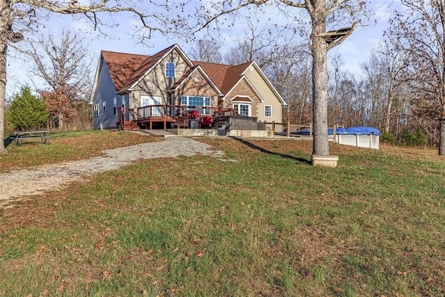 view of front of house featuring a swimming pool side deck and a front yard